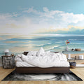 Beach wall mural in modern living room showing soft watercolor waves and golden sand