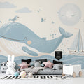 Ocean theme wallpaper bringing life to a modern nursery with gentle whale and sailboat design