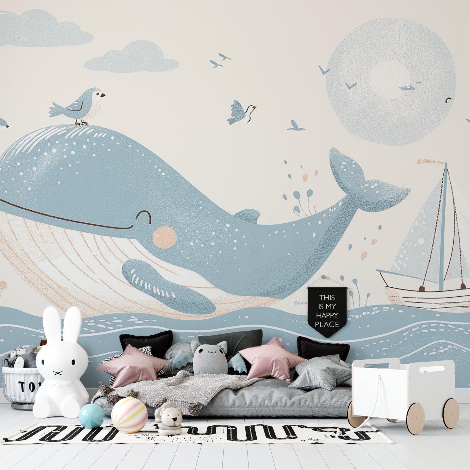 Ocean theme wallpaper bringing life to a modern nursery with gentle whale and sailboat design