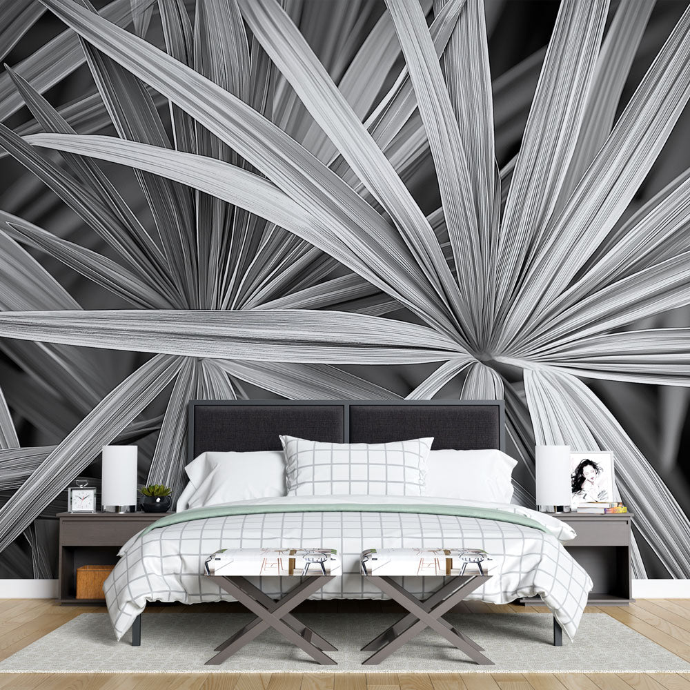 Black and white palm leaf wallpaper creating dramatic contrast in a modern living room with minimalist furniture