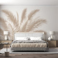 Palm leaf wallpaper mural creating a calm atmosphere in a bright modern living room with beige sofa and natural decor