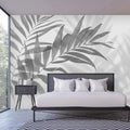 Modern Palm Leaf Mural Wallpaper creating a dramatic focal point in a minimalist living room setting
