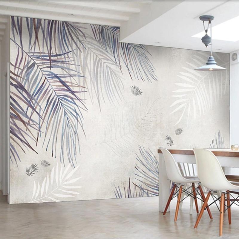 Palm leaves wallpaper in modern grey living room creating serene atmosphere