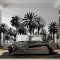 Black and white palm tree mural wallpaper creating dramatic impact in modern living room with minimalist furniture
