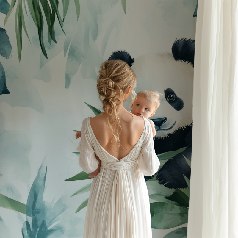 Panda wallpaper mural in bright nursery with white furniture showing watercolor tropical design