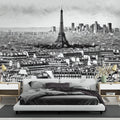 Paris cityscape mural wallpaper creating an elegant statement wall in a modern living room with minimal furniture