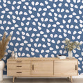 Modern living room featuring blue pattern wallpaper with white drops, creating a peaceful atmosphere