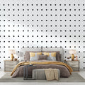 Modern black polka dot wallpaper in a bright living room setting, creating a fresh contemporary atmosphere