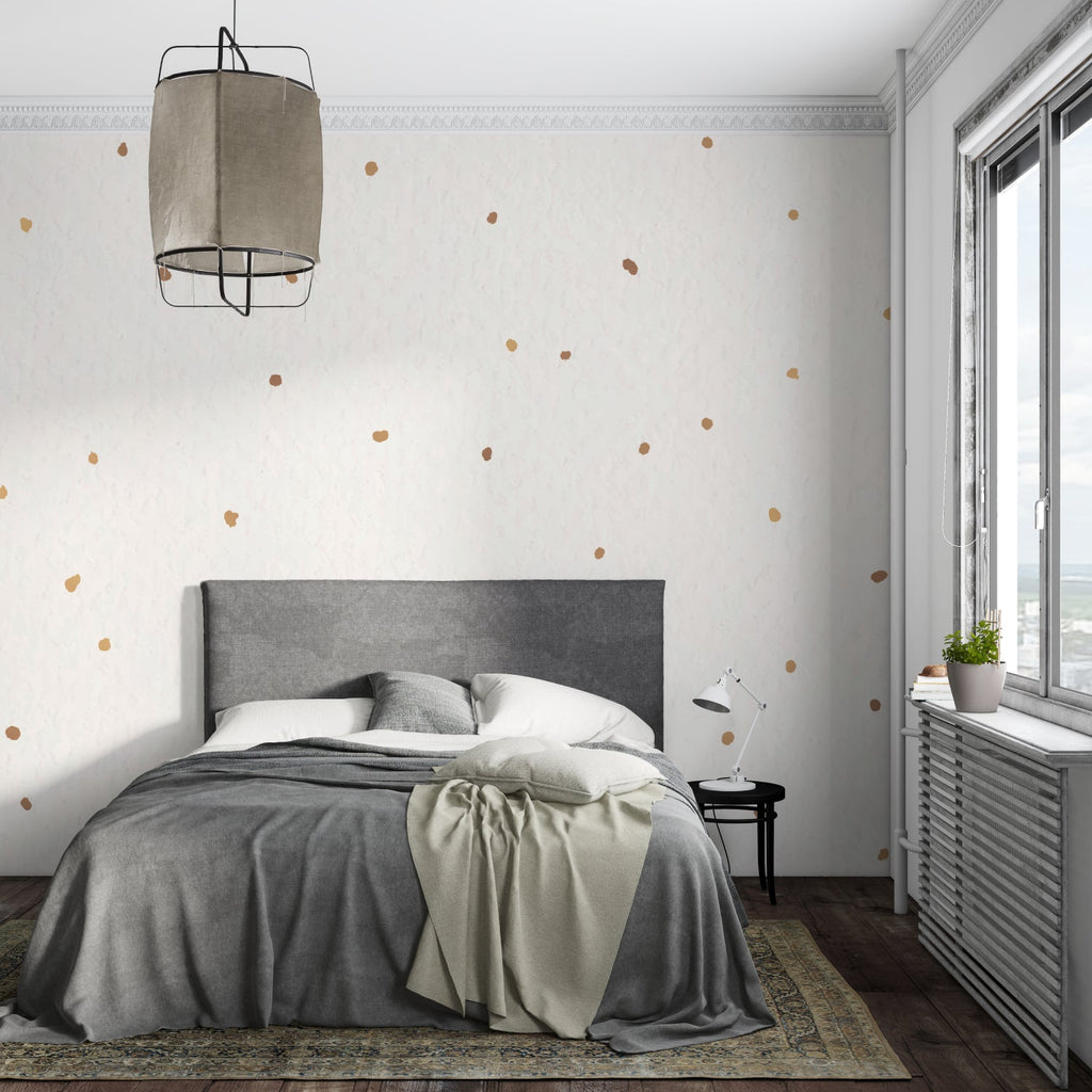 Gold and white dot wallpaper in dining room with evening lighting