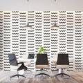 Modern wave pattern wallpaper creating movement in a minimal living room with white sofa and black accents