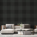 Green Buffalo Check Wallpaper creating a cozy atmosphere in a modern living room with leather furniture and natural light