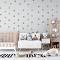 Silver polka dot wallpaper creating a magical atmosphere in a modern nursery with soft lighting