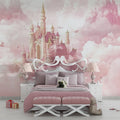 Princess castle wallpaper in a bright girl's bedroom, showing pink and gold castle mural above white furniture