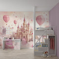 Princess castle wallpaper creating a magical atmosphere in a girl's bedroom with soft pink walls and dreamy decor
