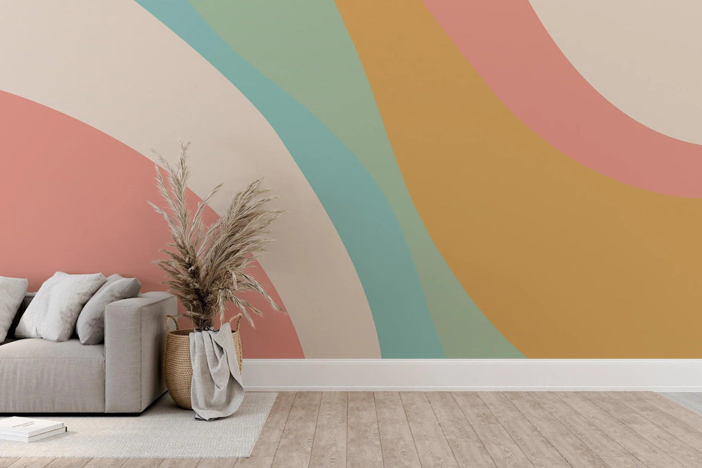 Pastel rainbow curved wallpaper adding soft movement to a bright nursery space