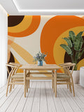 Retro geometric wallpaper with orange circles bringing warmth to a modern living room setting