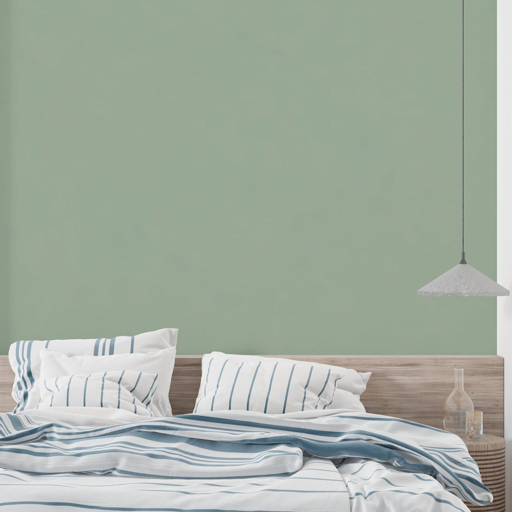 Home office featuring modern sage green wallpaper with minimal aesthetic