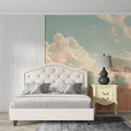 Sky mural wallpaper with pink clouds and flowers creating a cozy atmosphere in a modern living room