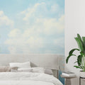 Cloud mural wallpaper creating an airy atmosphere in a modern living room with natural light
