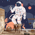 Space adventure wallpaper with floating astronaut in modern living room with blue accent wall