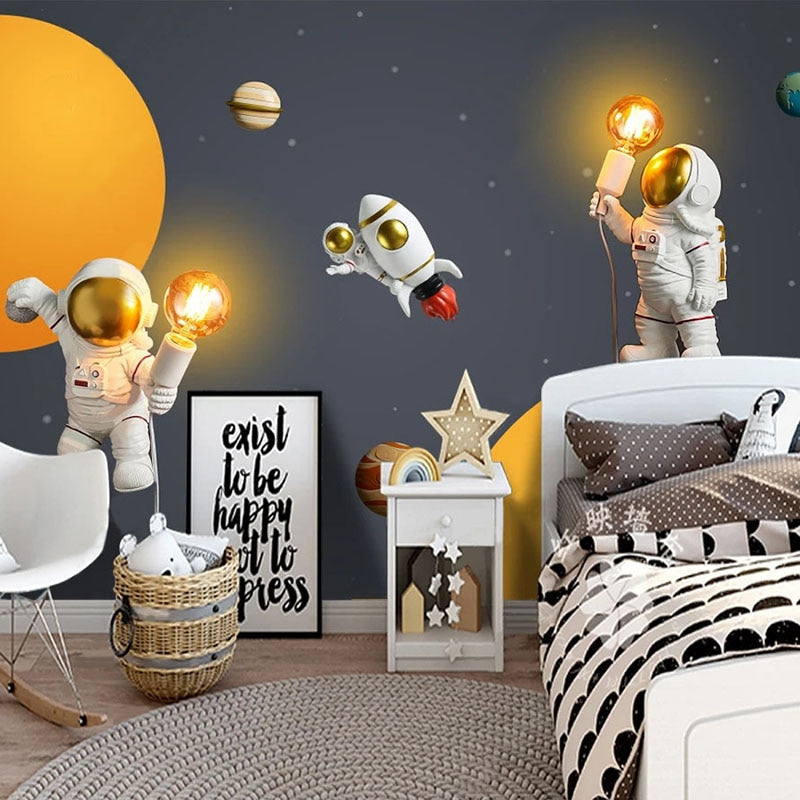 Space wallpaper with glowing planets creating magical atmosphere in modern kids bedroom