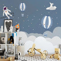 Space themed wallpaper with astronaut and hot air balloons creating magic in a modern nursery with soft lighting