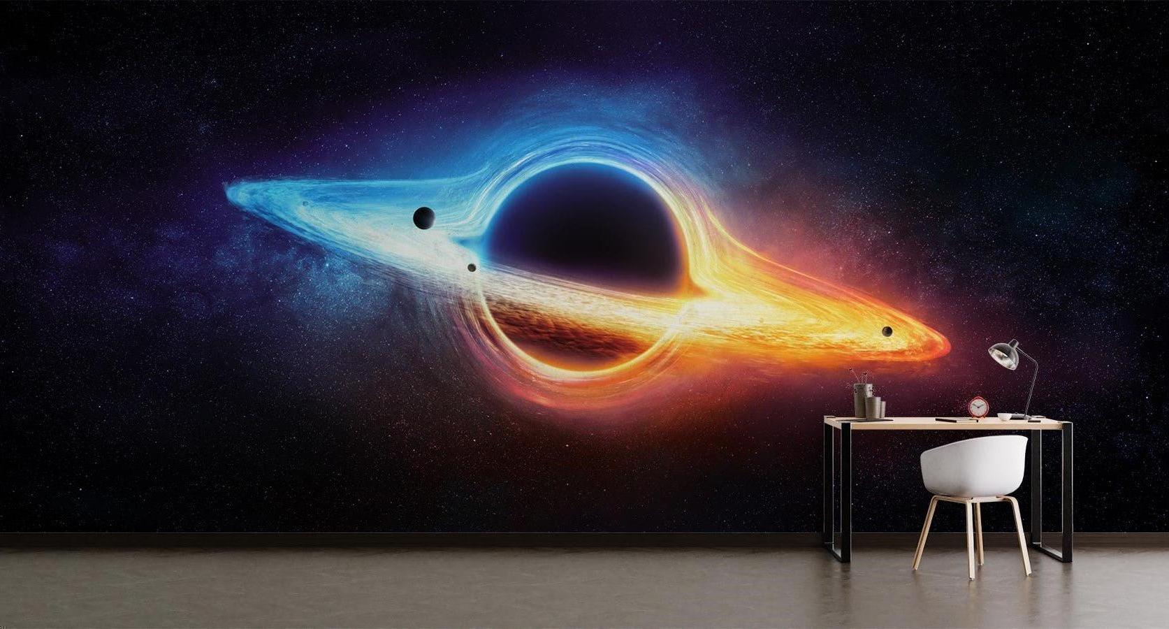 Black hole galaxy wallpaper creates stunning feature wall in gaming room setup