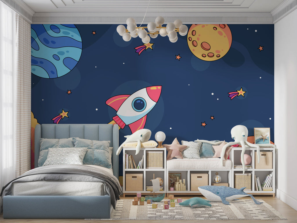 Space wallpaper mural with cartoon rocket shown in bright kids bedroom with blue accents and star decorations