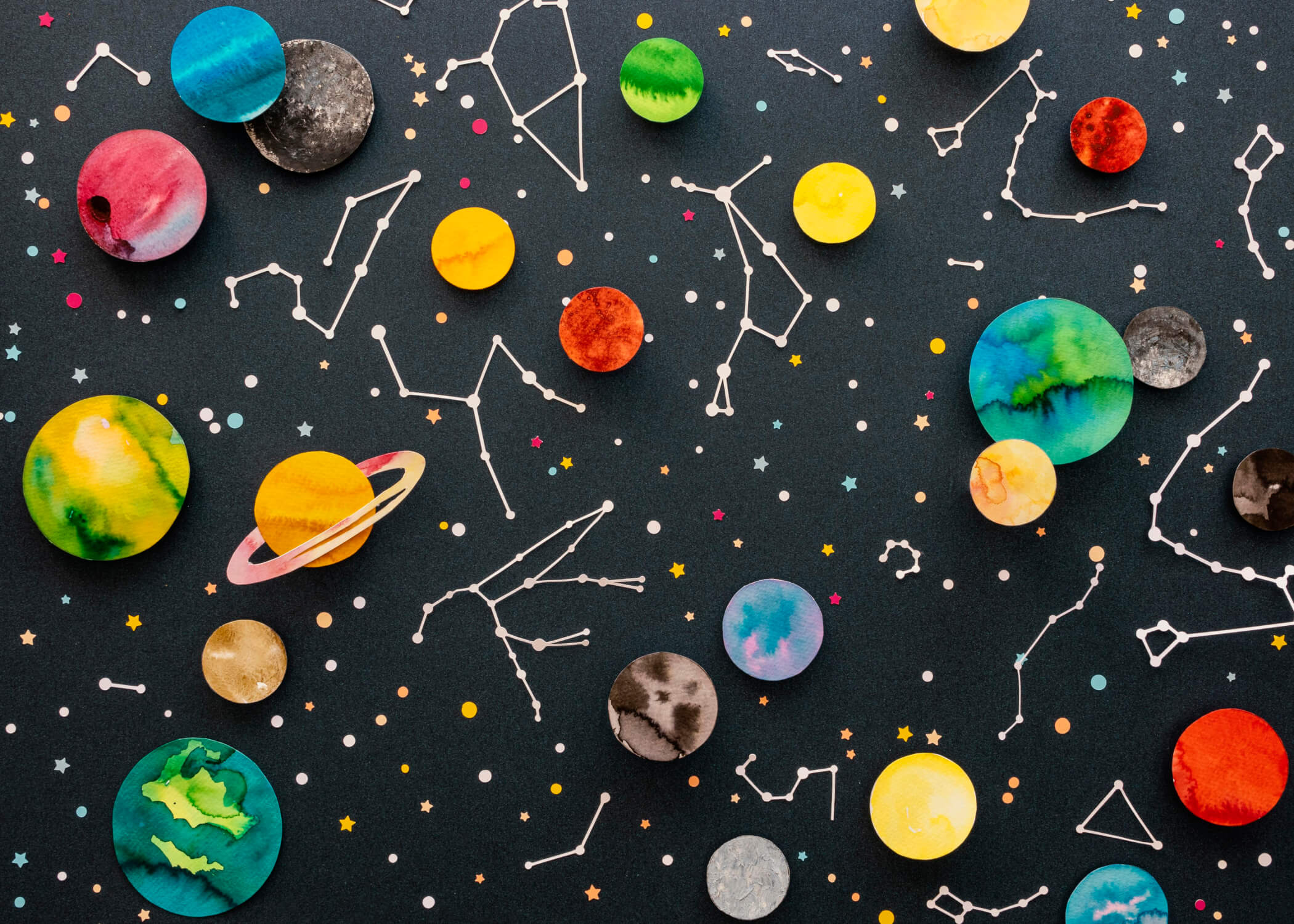 Design file showing vibrant watercolor planets and delicate constellation patterns