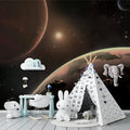 Space mural wallpaper creating a magical atmosphere in a modern kids bedroom with soft lighting