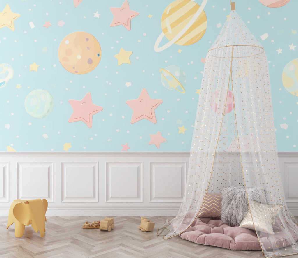 Playroom with celestial wallpaper showing scale of pastel planet design