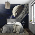 Space wallpaper with Saturn in modern kids bedroom, showing glowing rings against dark blue background