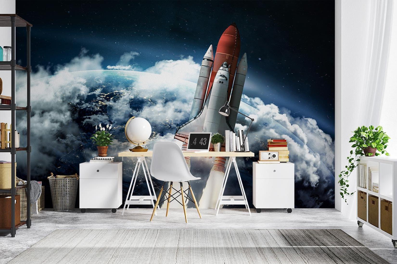 Kids bedroom with space launch mural wallpaper behind study desk and telescope