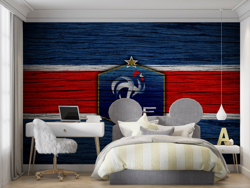 Sports themed wall mural in teen bedroom with gaming setup and football accessories