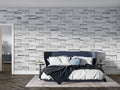 Modern grey stone block wallpaper in a minimalist living room creating depth and sophistication