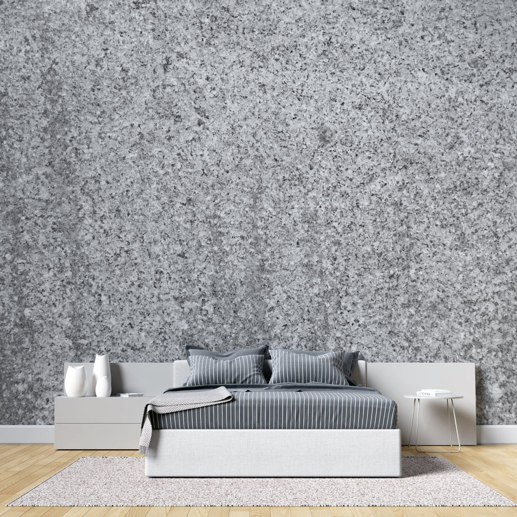 Modern grey stone wallpaper creating depth in a minimalist living room with natural light