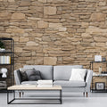 Stone effect wallpaper creating a natural beige accent wall in a modern living room with soft lighting and minimal furniture