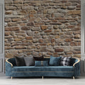 Stone wall mural in modern living room showing textured beige and terracotta tones creating warm atmosphere