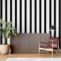Black and white striped wallpaper creating height in modern living room with gray sofa