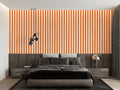 Modern orange striped wallpaper in a bright living room creating visual height and energy