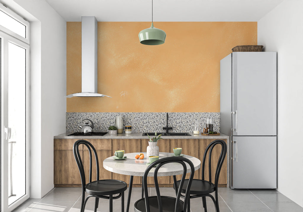 Orange textured wall mural in dining room with natural lighting