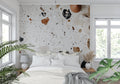 Modern terrazzo wallpaper in a bright living room, white and terracotta stone pattern adding texture to contemporary space