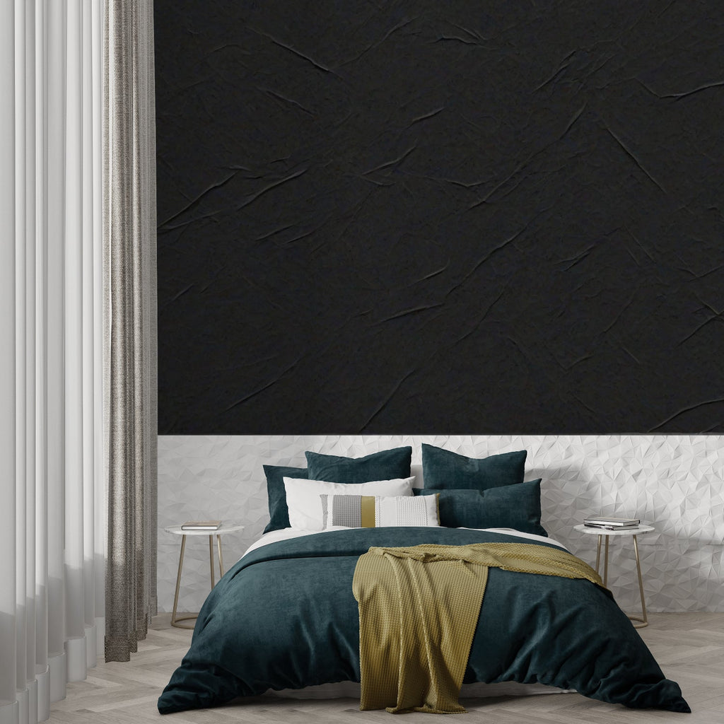 Black stone textured wallpaper in modern living room with grey sofa and natural light