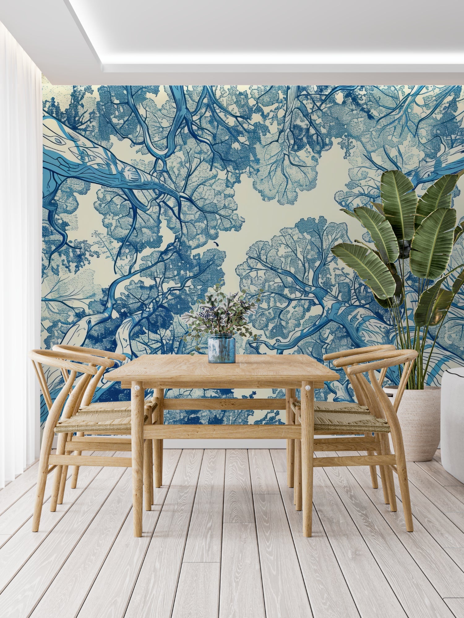 Blue botanical tree mural adding height to a cozy bedroom setting