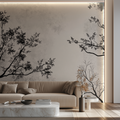 Black and white tree branch wallpaper creating depth in a modern living room setting