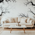 Black tree branch wallpaper creating depth in modern living room with grey sofa and natural light