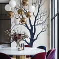 Minimalist black tree branch wallpaper creating drama in a modern living room with high ceilings