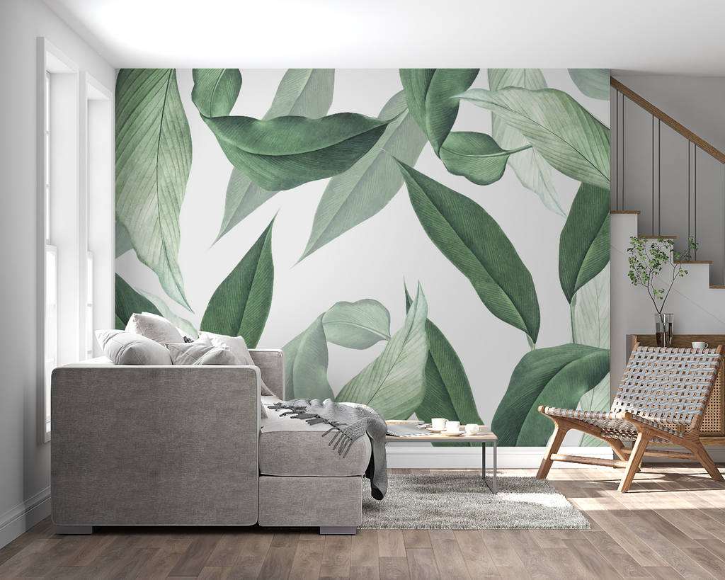 Large green leaves wallpaper in bright home office setting with wooden desk