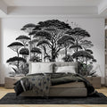 Black and white tropical forest wallpaper creating depth in modern living room with minimal furniture