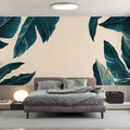 Tropical leaves wallpaper creating a calm atmosphere in a modern living room with white furniture and natural light